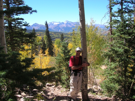 Marc hugging aspen tree on trail in Telluride